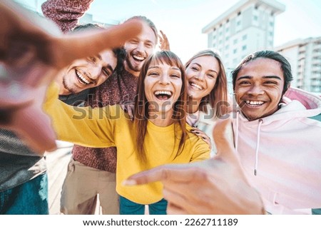Multicultural group of friends smiling together at camera outside - University students having fun in college campus - Millenial people hanging on summer day - Life style, friendship and youth culture