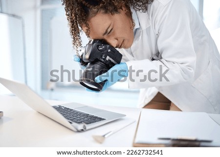 Black woman, forensic investigation and camera for laptop, it and cyber crime evidence on lab desk. Young technician, photography or computer for digital analysis of online criminal for cybersecurity Royalty-Free Stock Photo #2262732541