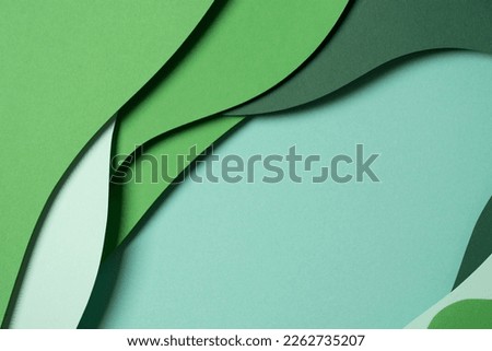 Abstract green color paper texture background. Minimal paper cut style composition with layers of geometric shapes and lines in green tone shades. Top view Royalty-Free Stock Photo #2262735207