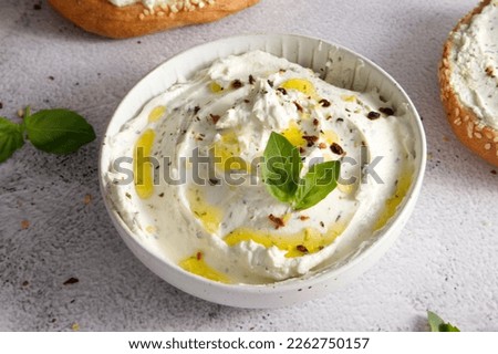 Cheese curd spread for breakfast with herbs, sun-dried tomatoes and olive oil close-up Royalty-Free Stock Photo #2262750157