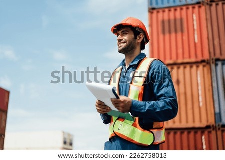A worker working at container , Man worker managing the import and export container. Royalty-Free Stock Photo #2262758013
