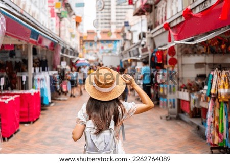 Young female tourist walking in Chinatown street market in Singapore Royalty-Free Stock Photo #2262764089