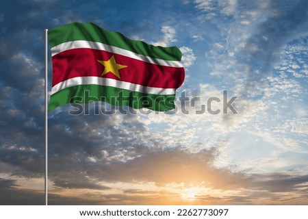 Waving National flag of Suriname in beautiful sky