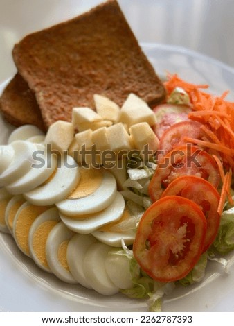 Salad with boiled egg and toast