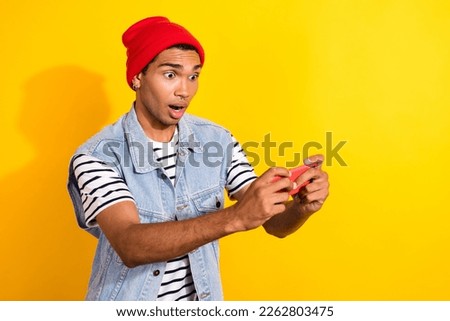 Photo of worried nervous man wear trendy clothes playing game new level modern technology empty space isolated on yellow color background