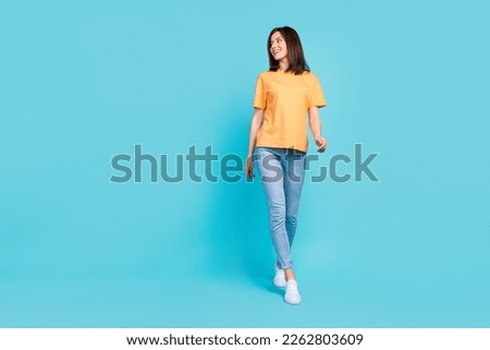 Full length portrait of stunning positive lady walking look empty space isolated on blue color background Royalty-Free Stock Photo #2262803609