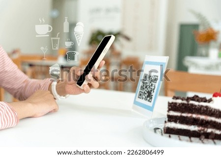 Woman use smartphone to scan QR code for order menu in cafe restaurant with a digital delivery. Choose menu and order accumulate discount. E wallet, technology, pay online, credit card, bank app.