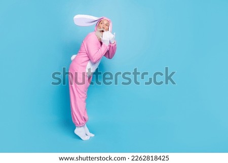 Full length photo of impressed funky retired man wear pink hare pajama open mouth empty space isolated blue color background