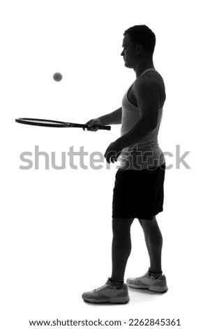 Silhouette of young man playing tennis on white background