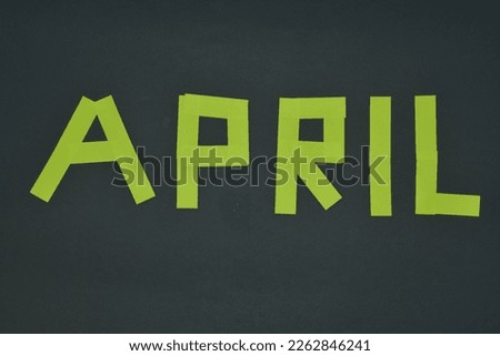 April month concept from a sticky notes paper gray background 