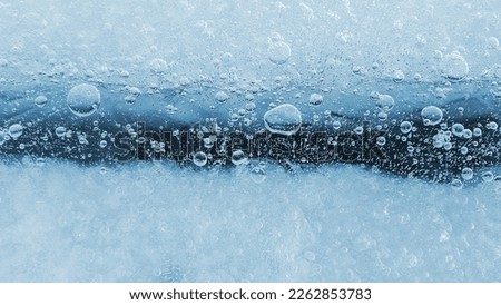 Ice surface with frozen air bubbles, close-up natural texture, ice pattern winter background