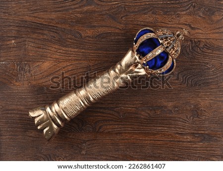golden scepter on wooden background Royalty-Free Stock Photo #2262861407