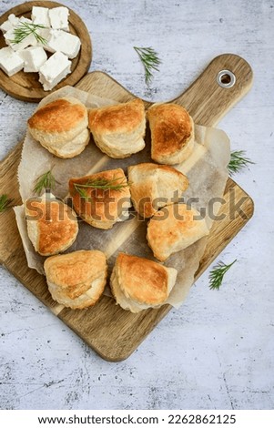 Fresh baked home made  Mini cheese puff pastries.Cheese pie with phyllo pastry and herbs Royalty-Free Stock Photo #2262862125