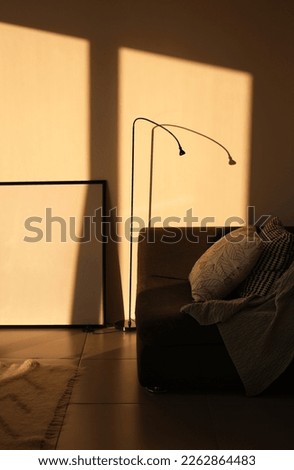 armchair with a picture in the living room flooded with sunlight