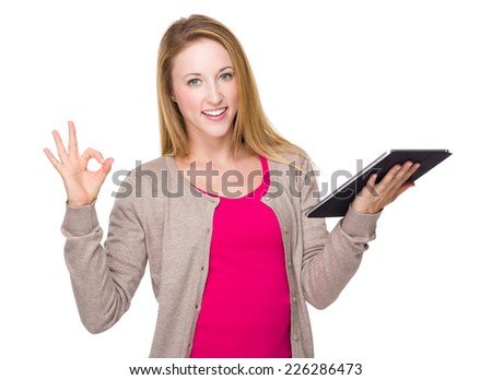 Caucasian woman with tablet and ok sign
