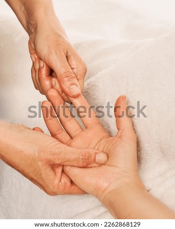 therapist massaging a woman's hands. Decontracting hand massage to relieve tension and pain Royalty-Free Stock Photo #2262868129