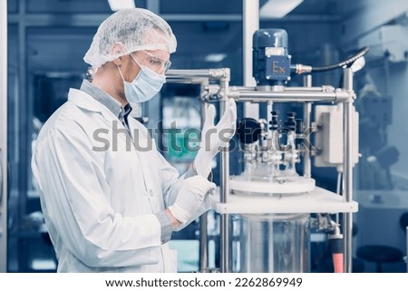 Scientist man working Cannabis CBD oil extraction for medical Science lab. Hemp oil extraction Thin Film Distillation Machine in Laboratory Plants Process.