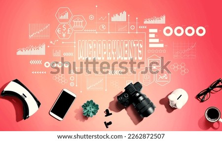 Micropayments theme with electronic gadgets and office supplies - flat lay Royalty-Free Stock Photo #2262872507