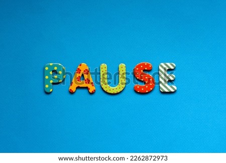 colored text  pause on blue paper background