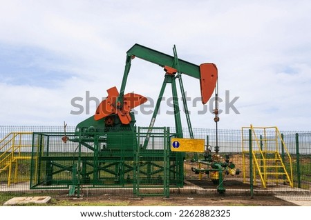 Oil pump jack under the blue sky. Brunei Field oil pump onshore production well Nodding Donkey