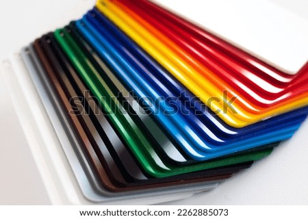 Multicolored plastic samples on a white background. Rainbow fan layout in the store. Color selection. Royalty-Free Stock Photo #2262885073