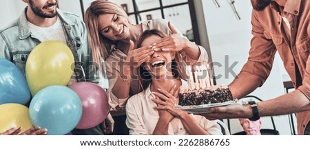 Group of young people preparing surprise party for their friend on birthday Royalty-Free Stock Photo #2262886765