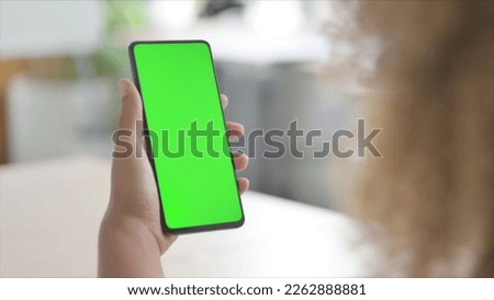 African American Woman Using Smartphone with Green Screen
