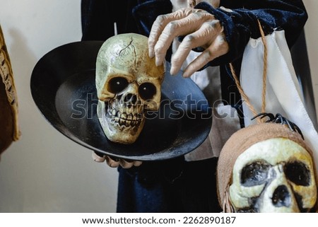 A skull in the hands of a skeleton. Halloween