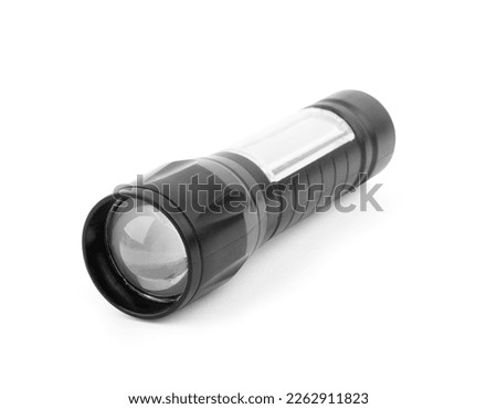 Black metallic flashlight close-up isolated on a white background.
