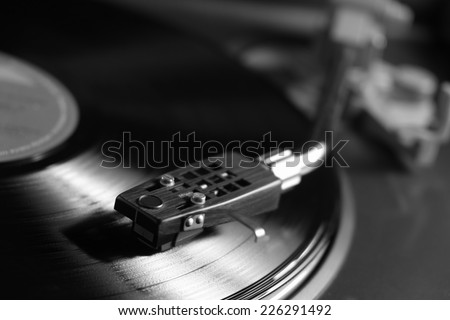 Picture of a vinyl record playing in black and white