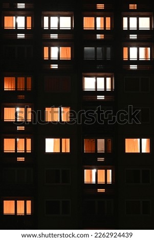 Apartment block windows at night tall Royalty-Free Stock Photo #2262924439