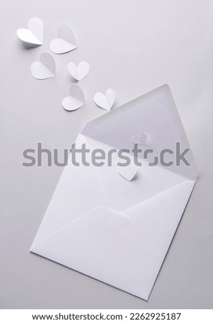 White mail envelope mockup with hearts on gray background
