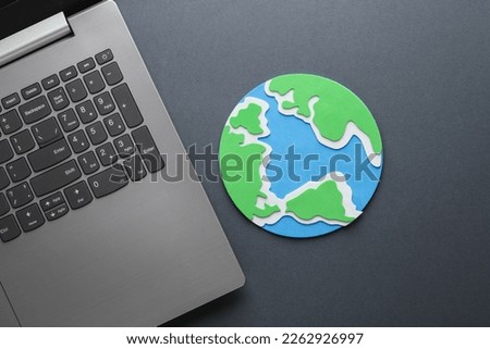 Laptop with earth planet on gray background