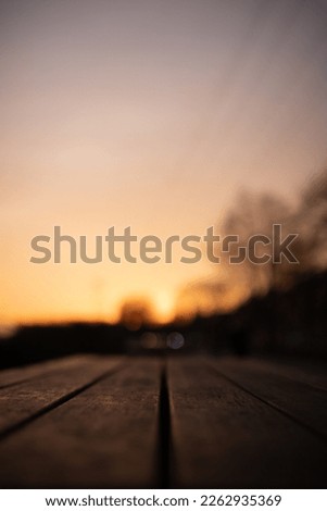 Close-up of wooden table in the park on the sunset