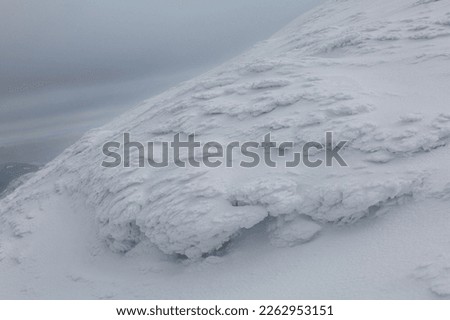 White snowy mount peak in the stormy day. Winter weather concept in the high mountains