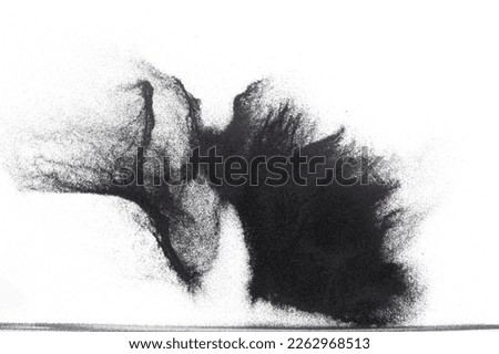 Small size black Sand flying explosion, carbon dust sands grain explode. Abstract cloud fly. Black colored sand splash throwing in Air. White background Isolated high speed shutter, throwing freeze Royalty-Free Stock Photo #2262968513