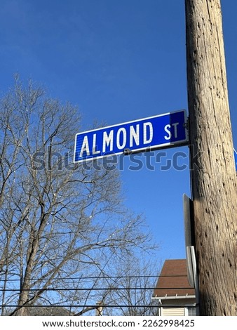 White text on vivid blue background Almond St. street sign in Williamsport, Pennsylvania.