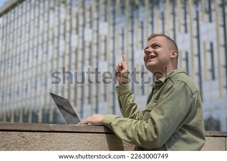 Caucasian man communicates in sign language via video link on laptop. 