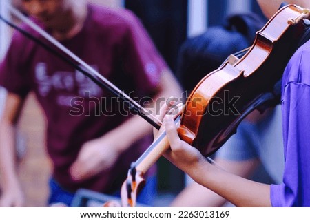 Close up pf teen high school students studying and playing violin at outdoor. Youth art, music club lifestyle and learning background. Royalty-Free Stock Photo #2263013169