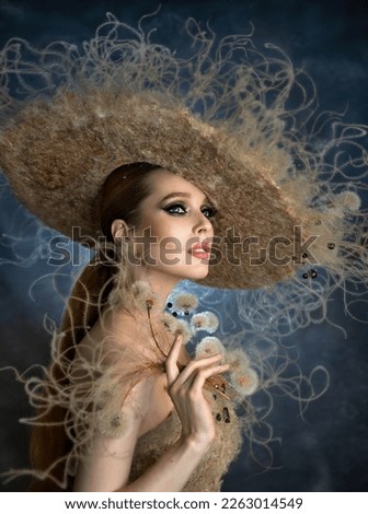 Photo session with dandelions. Beautiful girl in a hat. Model and spikes. Romantic girl. Natural image.