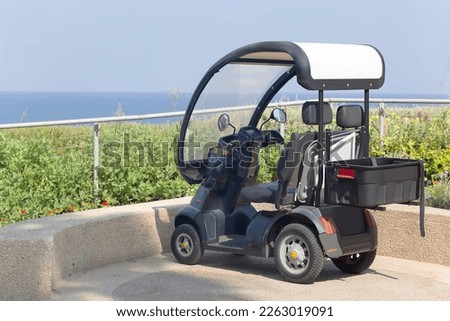 An electric scooter - car parked by the beach Royalty-Free Stock Photo #2263019091