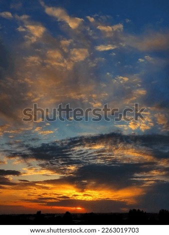 incredible blue and golden sunset landscape heavy clouds.