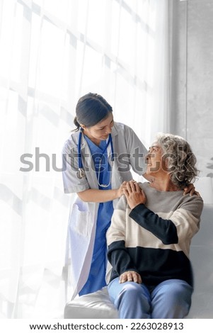 Young asian caretaker with 60s asia elderly woman consulting and encourage, take a history and recommend the right treatment, holding hands and encouraging Royalty-Free Stock Photo #2263028913