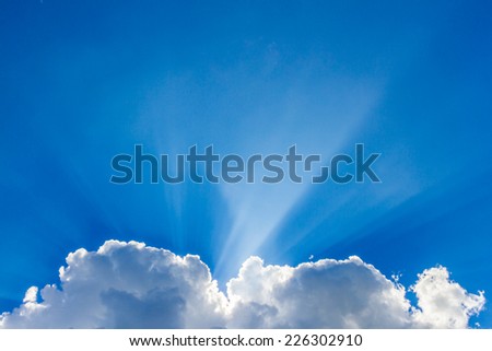 Sun peeking through the clouds background