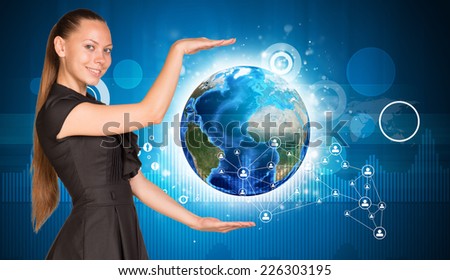 Beautiful businesswoman holding Earth. Network in background. Elements of this image furnished by NASA