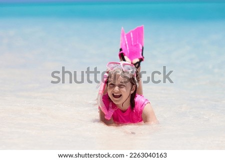 Kids snorkel. Beach fun. Children snorkeling in tropical sea on family summer vacation on exotic island. Child with mask and fins. Travel with kid. Little girl learning to dive. Diving holiday