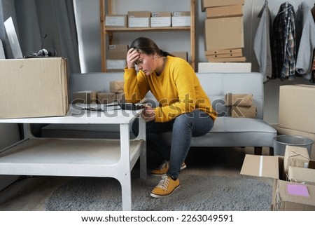 Female small business owner thoughtful serious doubtful in stress worry with financial problem in SME crisis small business challenges impact, working in home office. Copy space Royalty-Free Stock Photo #2263049591