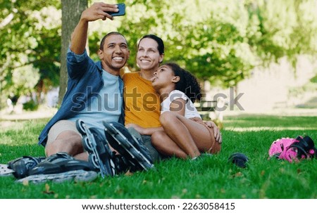 Interracial family selfie, girl and park with rollerblades, bonding or smile for profile picture, happy or holiday. Black man, mom and child for happiness, hug or diversity for social media on grass