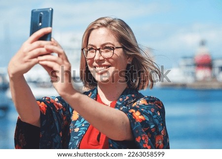 Selfie, travel and woman with phone by harbor enjoying vacation, holiday and journey in Amsterdam. Freedom, adventure and happy female take picture for social media, post and memory on smartphone