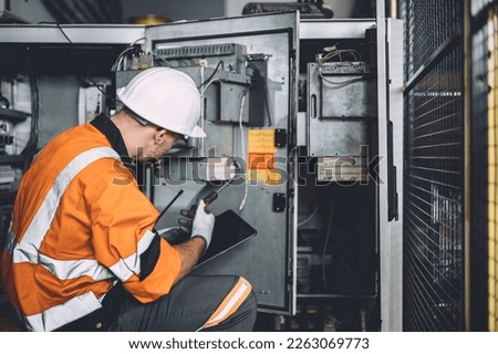 electricity engineer male dangerous working fix service high voltage electrical cabinet. worker repair electric surge problem problem in industry factory. Royalty-Free Stock Photo #2263069773